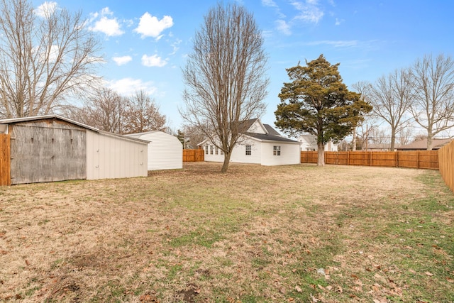 view of yard with an outdoor structure and a fenced backyard