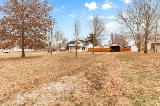 view of yard with a carport and an outdoor structure