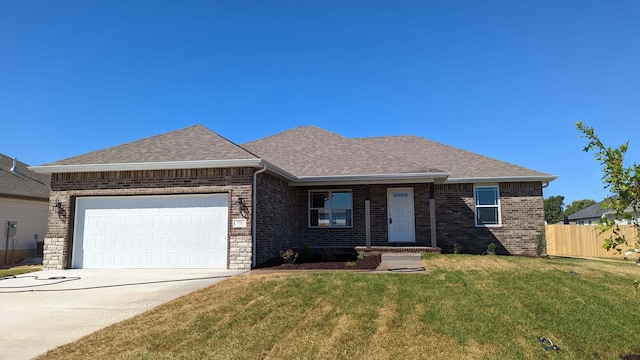 ranch-style house with a garage and a front lawn