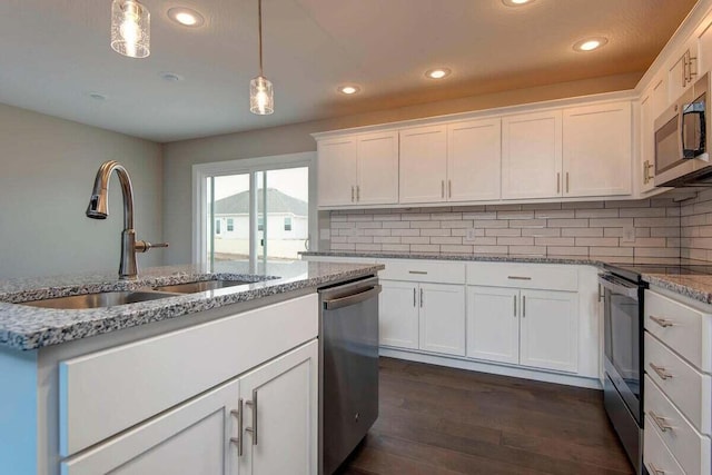 kitchen with white cabinetry, hanging light fixtures, stainless steel appliances, and sink