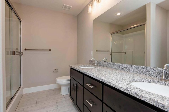 bathroom featuring vanity, toilet, and walk in shower