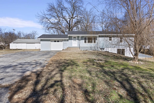 single story home featuring a garage and a front lawn