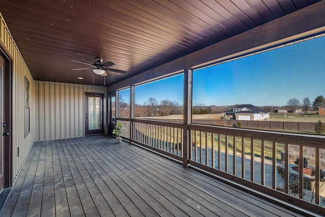 sunroom / solarium featuring ceiling fan