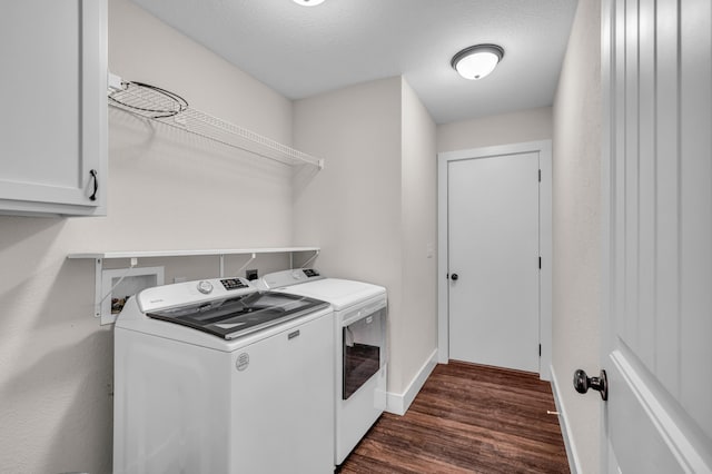 laundry area with cabinets, dark hardwood / wood-style flooring, washer and dryer, and a textured ceiling