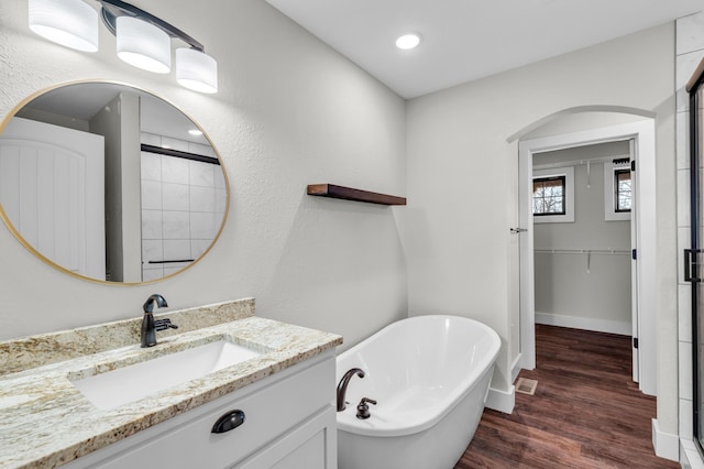 bathroom with vanity, a bathtub, and hardwood / wood-style floors