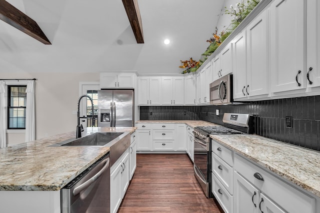 kitchen featuring sink, appliances with stainless steel finishes, white cabinetry, dark hardwood / wood-style flooring, and beamed ceiling