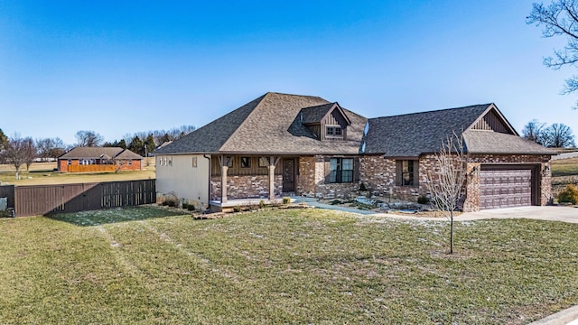 view of front of home with a garage and a front lawn