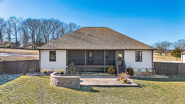 rear view of house with a patio area and a lawn