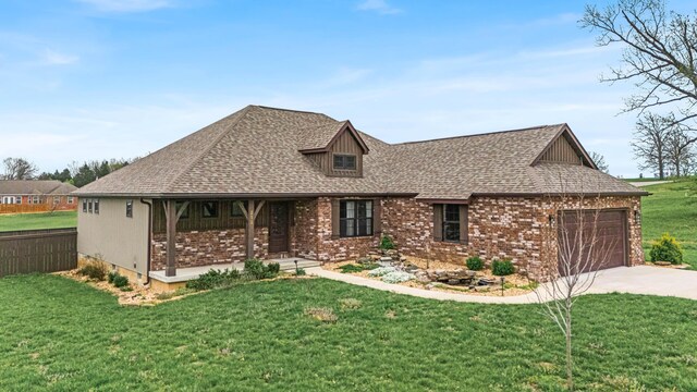 2320 Aid Hodgson Ln, West Plains, MO 65775 - view of front of house with brick siding, a front yard, driveway, and a garage
