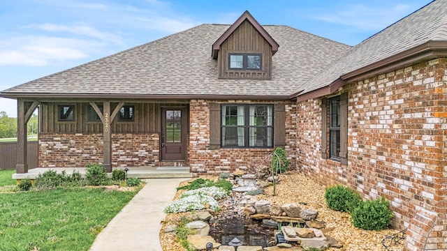 2320 Aid Hodgson Ln, West Plains, MO 65775 - view of front facade with brick siding, a shingled roof, and a porch