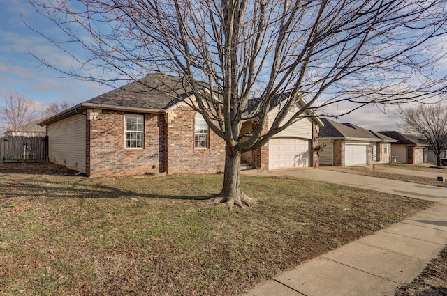 view of side of home with a garage and a yard