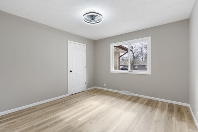 spare room featuring light wood-type flooring