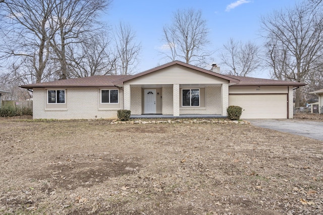 ranch-style house featuring a garage and covered porch