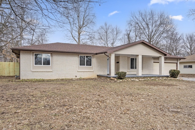 single story home featuring a porch and a garage