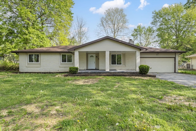 ranch-style home featuring driveway, covered porch, a front yard, and a garage