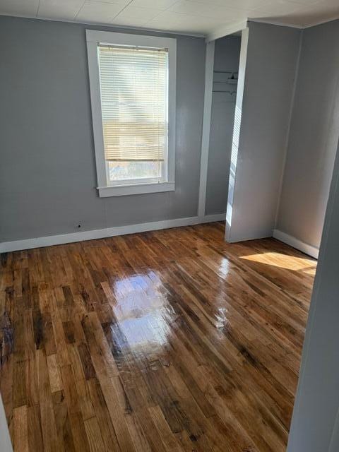 unfurnished room featuring hardwood / wood-style floors and a wealth of natural light