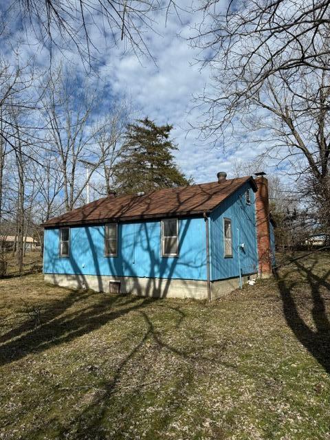 view of home's exterior with a lawn