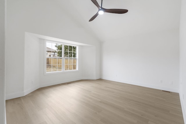 spare room with ceiling fan, high vaulted ceiling, and light hardwood / wood-style flooring