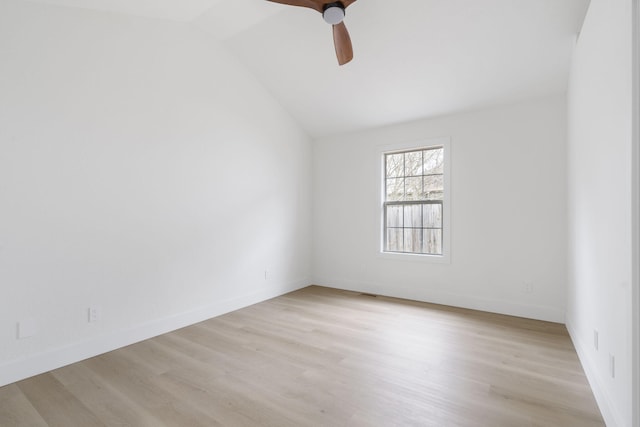 spare room with ceiling fan, vaulted ceiling, and light hardwood / wood-style flooring