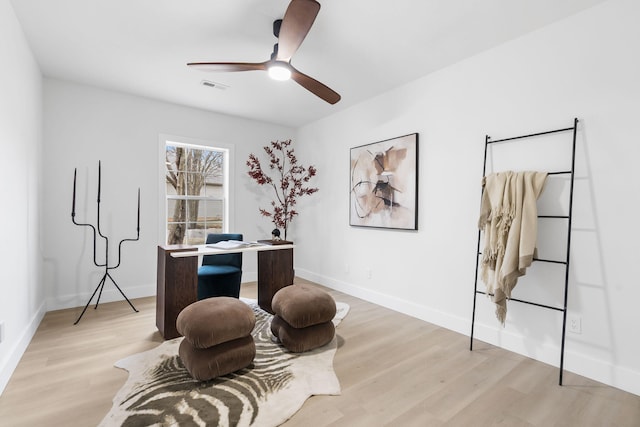 office with ceiling fan and light hardwood / wood-style floors