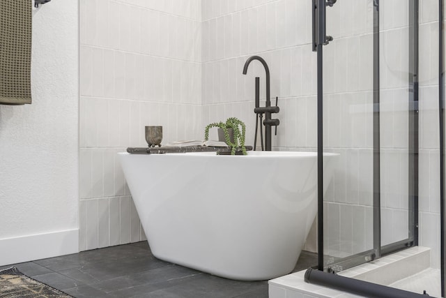 bathroom featuring separate shower and tub