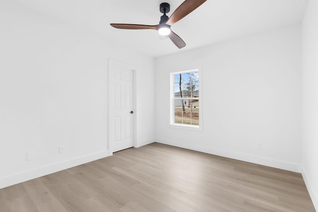 spare room with ceiling fan and light wood-type flooring