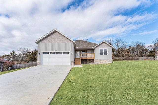 view of front of house with a garage and a front lawn