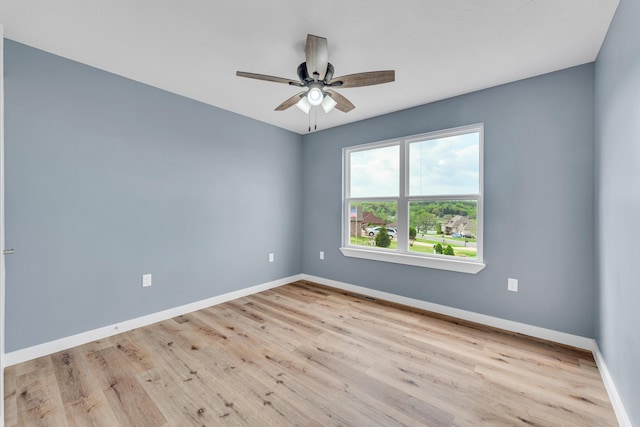 spare room featuring ceiling fan and light hardwood / wood-style flooring