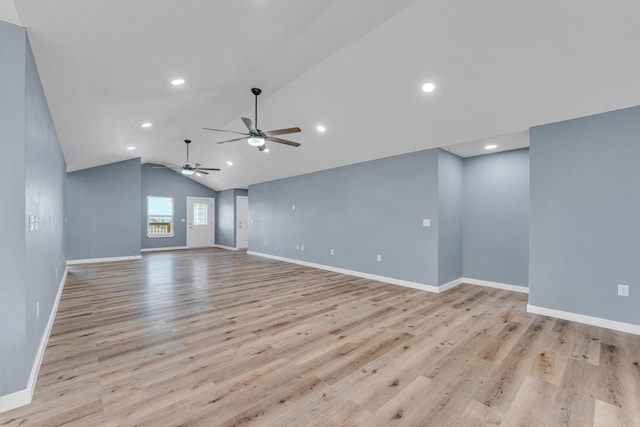 empty room with light hardwood / wood-style flooring, vaulted ceiling, and ceiling fan