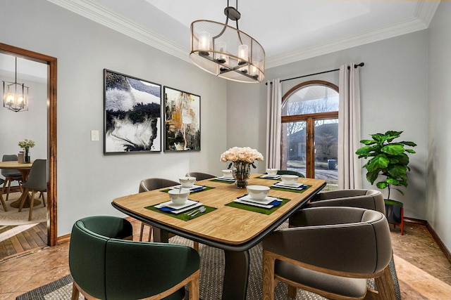 dining space featuring an inviting chandelier, crown molding, and french doors