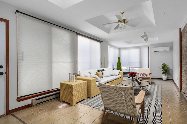 living room with a wall mounted AC, a baseboard heating unit, light tile patterned floors, ceiling fan, and a tray ceiling