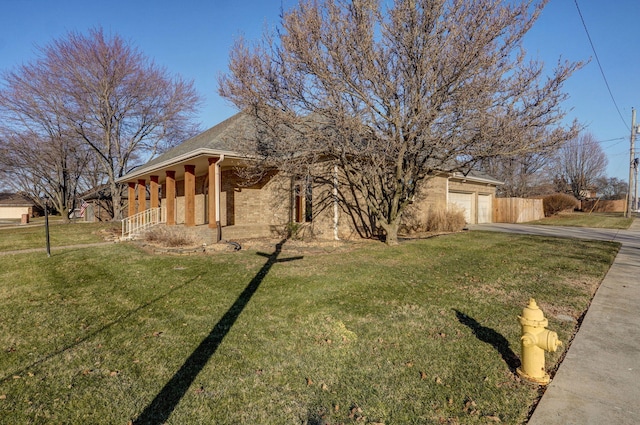 exterior space with a garage, a porch, and a yard