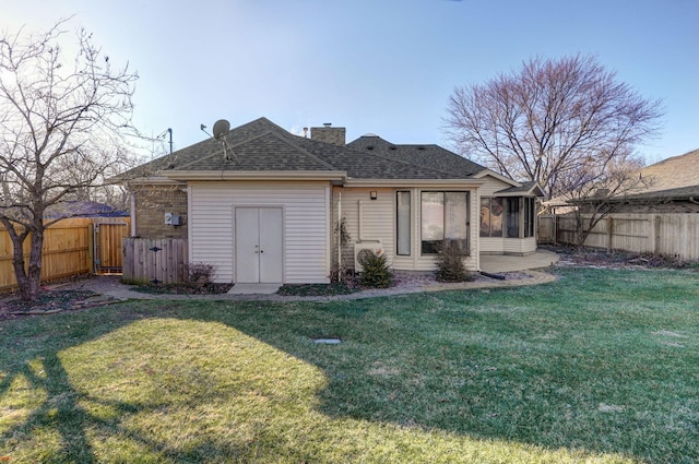 back of house featuring a yard