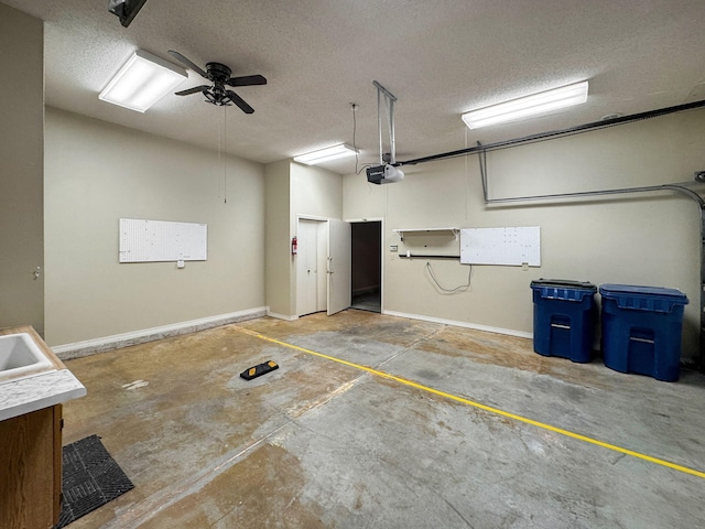 garage with a garage door opener and ceiling fan