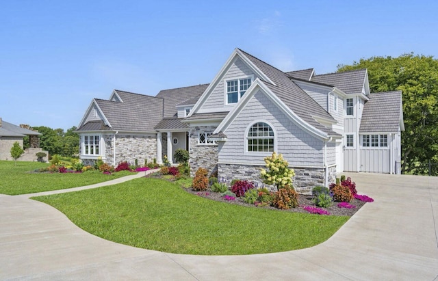 view of front of home with a garage and a front lawn