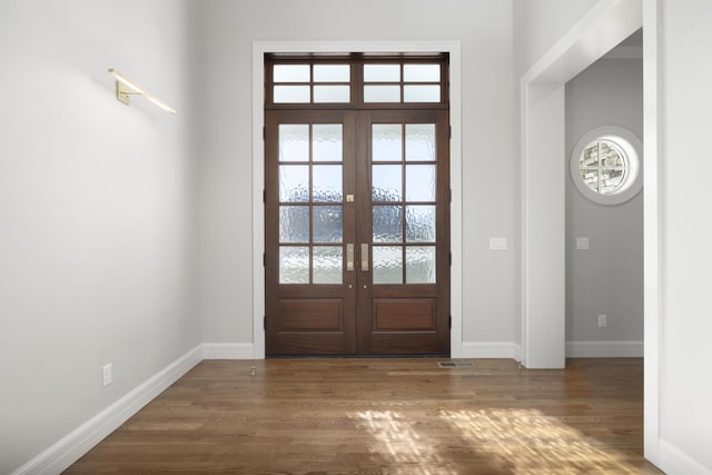 entryway with french doors and dark hardwood / wood-style floors