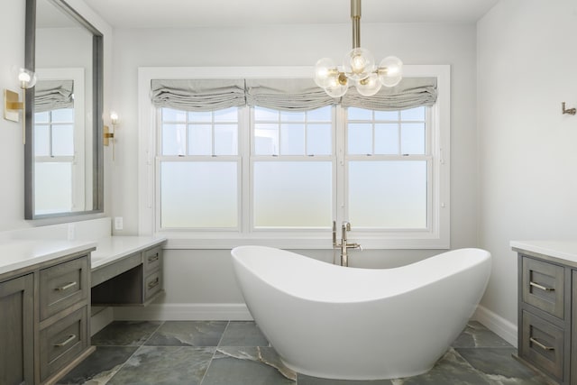 bathroom with a washtub, vanity, plenty of natural light, and an inviting chandelier