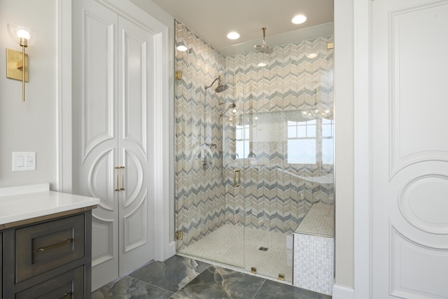 bathroom with vanity and tiled shower