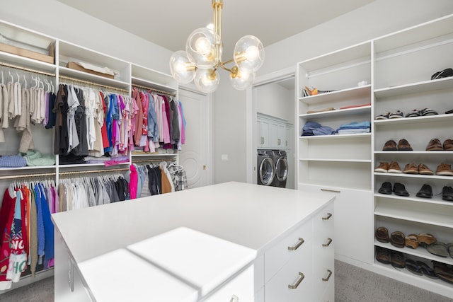 spacious closet with an inviting chandelier and separate washer and dryer