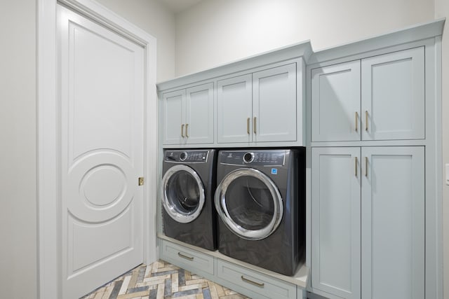 laundry room with cabinets and separate washer and dryer