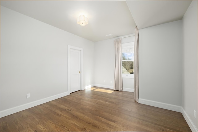 unfurnished room featuring dark hardwood / wood-style flooring