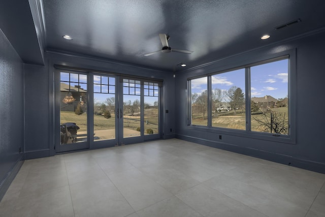 interior space with a textured ceiling and ceiling fan