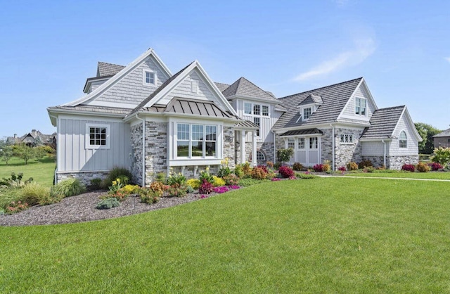 view of front of property featuring a garage and a front lawn