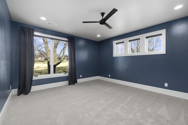 spare room with light carpet and ceiling fan