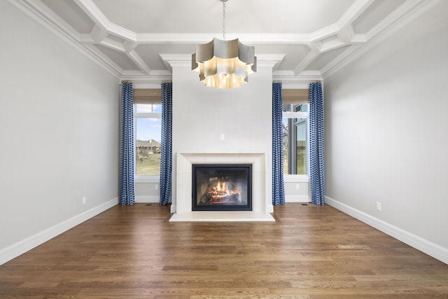 unfurnished living room featuring coffered ceiling, crown molding, dark wood-type flooring, and a chandelier