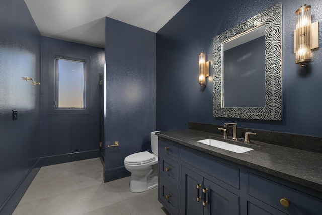 bathroom with vanity, tile patterned floors, and toilet