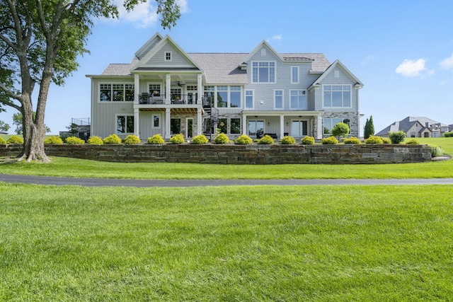 view of front of property with a balcony and a front yard