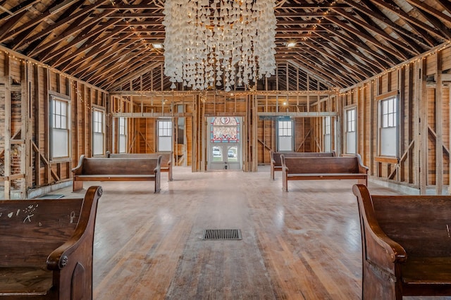 misc room featuring wood-type flooring and high vaulted ceiling