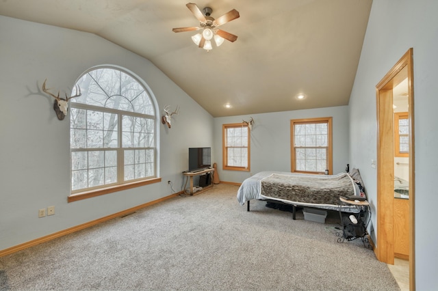 carpeted bedroom with ceiling fan and vaulted ceiling