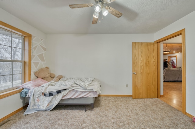 bedroom featuring ceiling fan and light carpet